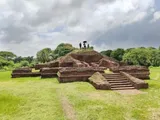 Terraced brick ruins under a cloudy sky