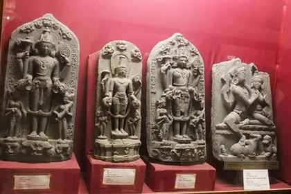 A row of carved stone sculptures in a museum gallery